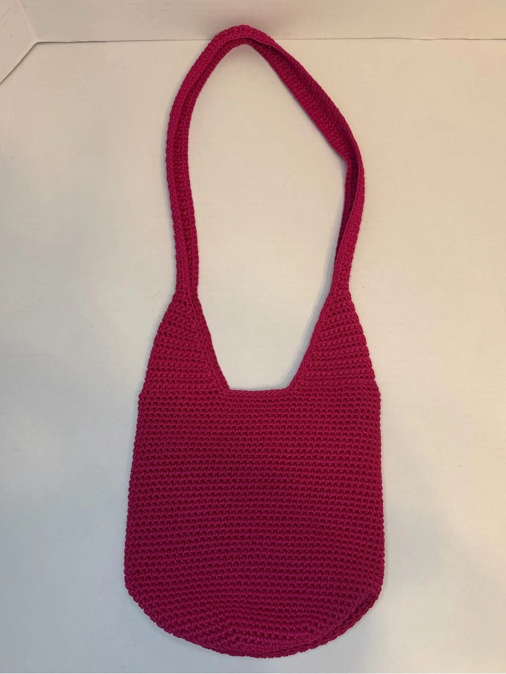 The Sak raspberry, pink handcrafted crochet hobo shoulder bag
